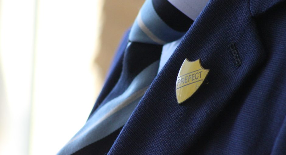 Vintage Prefect badge on old school uniform